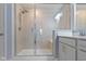 Bathroom featuring tiled shower with glass door and built in bench at 13783 Tender Dr, Carmel, IN 46032