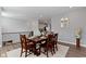 Dining room with wood table and seating for six overlooking the kitchen at 13783 Tender Dr, Carmel, IN 46032