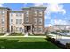 Beautiful new construction townhome featuring a brick facade, manicured lawn and a welcoming front porch at 13783 Tender Dr, Carmel, IN 46032