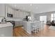 Kitchen with modern stainless appliances, white cabinets, and a large center island with bar stool seating at 13783 Tender Dr, Carmel, IN 46032