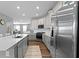 Kitchen with stainless appliances, white cabinets and subway tile backsplash at 13783 Tender Dr, Carmel, IN 46032