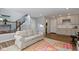 Spacious living room with open floor plan, featuring a cozy sofa and staircase access at 13783 Tender Dr, Carmel, IN 46032