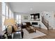 Living room with a leather sofa, fireplace, TV, and staircase at 13783 Tender Dr, Carmel, IN 46032