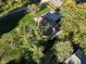 An aerial view of a charming home surrounded by lush trees and a well-maintained lawn at 1402 Hornaday Rd, Brownsburg, IN 46112