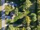 A high angle view shows a property with a large, well-maintained yard and mature trees at 1402 Hornaday Rd, Brownsburg, IN 46112