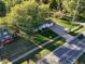 Aerial view showcasing a home, a well-manicured lawn, mature trees, and street views at 1402 Hornaday Rd, Brownsburg, IN 46112