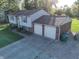 Aerial view of home featuring a two-car garage, long driveway, and well-maintained lawn at 1402 Hornaday Rd, Brownsburg, IN 46112