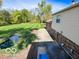 View of the backyard featuring a scenic pond, lush lawn, and the side of the house at 1402 Hornaday Rd, Brownsburg, IN 46112