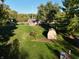Aerial view of a serene backyard with a shed and lush greenery, ideal for relaxation at 1402 Hornaday Rd, Brownsburg, IN 46112