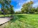 Beautiful view of a lush green lawn, mature trees, and a storage shed on a sunny day at 1402 Hornaday Rd, Brownsburg, IN 46112