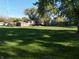 View of a sprawling backyard with a well-manicured lawn and mature trees providing ample shade at 1402 Hornaday Rd, Brownsburg, IN 46112