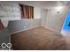 Spacious basement featuring carpet flooring, storage shelves, and neutral-colored walls at 1402 Hornaday Rd, Brownsburg, IN 46112