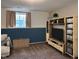 Finished basement featuring plush chair and a large bookcase perfect for relaxation or entertainment at 1402 Hornaday Rd, Brownsburg, IN 46112