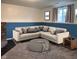 Finished basement area with comfortable seating area featuring plush sectional couch and ottoman at 1402 Hornaday Rd, Brownsburg, IN 46112