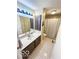 Cozy bathroom offers a vanity with a mirrored cabinet, neutral color scheme, and shower at 1402 Hornaday Rd, Brownsburg, IN 46112