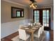 Dining room with wood floors features a place setting for eight and large doors leading to the back deck at 1402 Hornaday Rd, Brownsburg, IN 46112