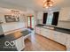 Bright kitchen featuring a window, white cabinetry, dark countertops and a cozy dining area at 1402 Hornaday Rd, Brownsburg, IN 46112
