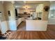 Open concept kitchen offers white cabinetry, appliances, and views to the living areas at 1402 Hornaday Rd, Brownsburg, IN 46112