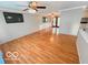 Spacious living room features hardwood floors and offers views into the dining room and kitchen at 1402 Hornaday Rd, Brownsburg, IN 46112