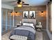 Stylishly designed bedroom features a wood accent wall, barn door, and modern furnishings at 1402 Hornaday Rd, Brownsburg, IN 46112