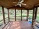 Covered porch with wood flooring and screened walls offering views of the picturesque backyard at 1402 Hornaday Rd, Brownsburg, IN 46112