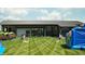 Outdoor community area with cornhole and bouncy house on a well-maintained lawn at 1463 Crosstie Cir, Westfield, IN 46074