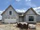 Exterior of an unfinished home, with a garage and brick stacked near the front entrance at 1463 Crosstie Cir, Westfield, IN 46074