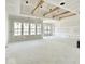 Bright, open living space with large windows and decorative ceiling beams, awaiting final touches at 1463 Crosstie Cir, Westfield, IN 46074