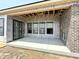 Covered patio area features large windows and a brick accent wall at 1463 Crosstie Cir, Westfield, IN 46074