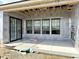 Covered outdoor patio area with sliding glass doors and multiple windows, perfect for entertaining at 1463 Crosstie Cir, Westfield, IN 46074