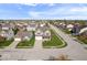 Expansive aerial view of a residential neighborhood with well-manicured lawns and tree-lined streets on a sunny day at 15152 Fallen Leaves Ln, Noblesville, IN 46060