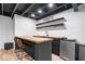 Basement bar area featuring butcher block counters, black cabinets, and stainless steel refrigerator at 15152 Fallen Leaves Ln, Noblesville, IN 46060