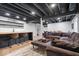 Finished basement featuring a bar, open ceiling, and comfortable seating area at 15152 Fallen Leaves Ln, Noblesville, IN 46060