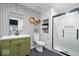 Renovated bathroom with patterned wallpaper and a walk-in shower with white subway tiles at 15152 Fallen Leaves Ln, Noblesville, IN 46060
