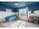 Cozy bedroom features a blue accent wall and ceiling, a large window, and a light-colored carpet at 15152 Fallen Leaves Ln, Noblesville, IN 46060