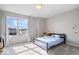 Serene bedroom features natural light from the window and a neutral color scheme with a blue bed at 15152 Fallen Leaves Ln, Noblesville, IN 46060