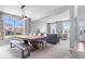 Bright, open dining area featuring a large wooden table and views of the neighborhood at 15152 Fallen Leaves Ln, Noblesville, IN 46060