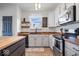 Well-equipped kitchen features modern appliances and white cabinets with a view to outside at 15152 Fallen Leaves Ln, Noblesville, IN 46060