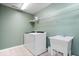 Laundry room featuring a utility sink and a white washer and dryer at 15152 Fallen Leaves Ln, Noblesville, IN 46060