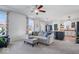 Cozy living room features plush carpeting, updated lighting and a comfortable sofa and ottoman at 15152 Fallen Leaves Ln, Noblesville, IN 46060