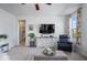 Open-concept living room features a TV and neutral decor with a view to a bathroom at 15152 Fallen Leaves Ln, Noblesville, IN 46060
