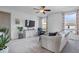 Bright living area with accent wall, ceiling fan, and neutral colors with comfortable seating at 15152 Fallen Leaves Ln, Noblesville, IN 46060