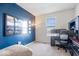 Bright office space features a gray carpet, blue accent wall with city art, and a comfortable chair at 15152 Fallen Leaves Ln, Noblesville, IN 46060