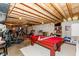 Spacious basement area with pool table, exercise equipment, and exposed wooden ceiling at 15885 Symphony Blvd, Noblesville, IN 46060