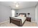 This bedroom features a wooden bed frame, matching bedside tables, lamps, carpet flooring, and light grey walls at 15885 Symphony Blvd, Noblesville, IN 46060