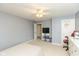 This carpeted bedroom features grey walls, with a twin bed, ceiling fan, red chair, and white dresser at 15885 Symphony Blvd, Noblesville, IN 46060