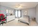 This bedroom has carpet flooring, grey walls, and a twin bed, with a red gaming chair next to a white dresser at 15885 Symphony Blvd, Noblesville, IN 46060