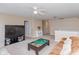 Expansive bonus room with neutral tones, ample space, and a large television at 15885 Symphony Blvd, Noblesville, IN 46060