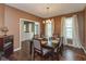 Elegant dining room with dark wood floors, pendant lighting, and a classic six-seat dining set at 15885 Symphony Blvd, Noblesville, IN 46060