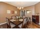 Formal dining room featuring a six-seat table, hardwood floors, and contemporary chandelier lighting at 15885 Symphony Blvd, Noblesville, IN 46060